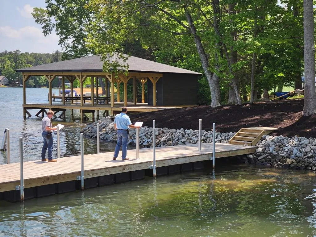 Contractor inspecting Lake Anna dock damage during on-site assessment
