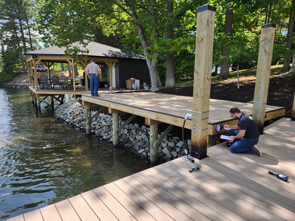 Homeowner inspecting dock decking and hardware for wear