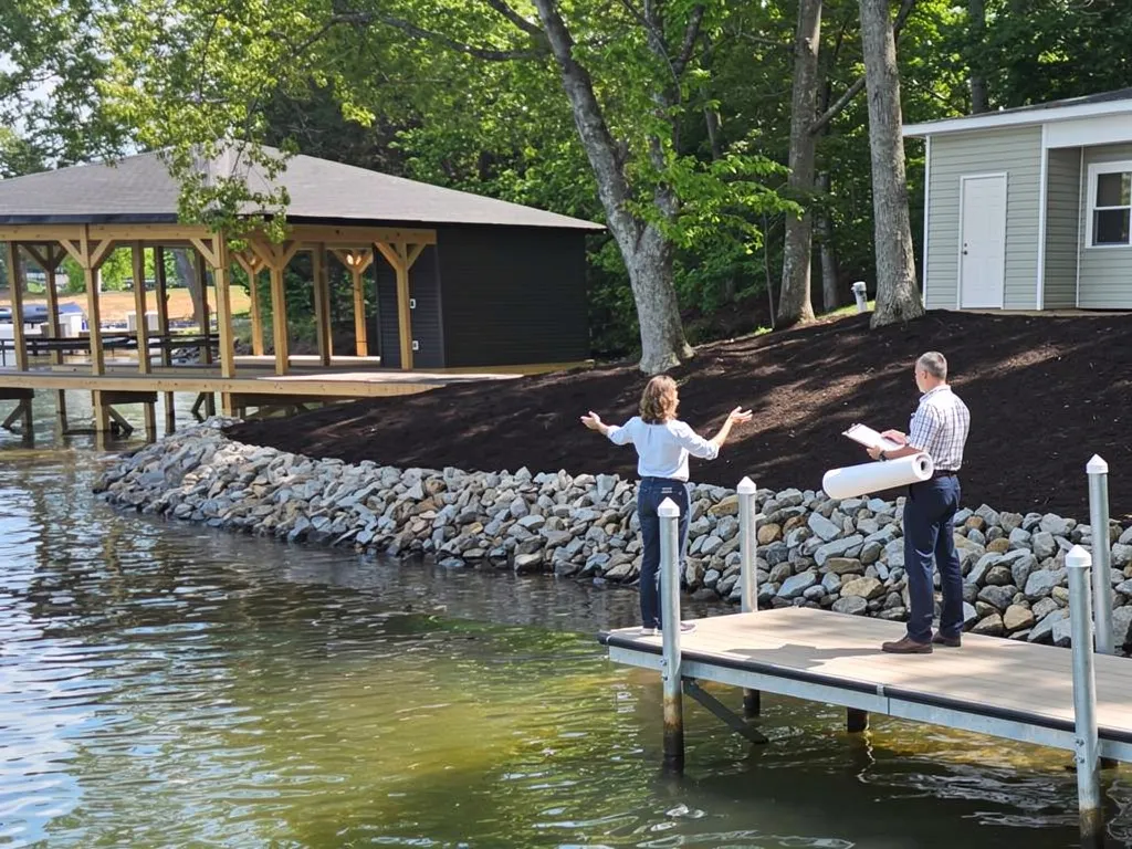 Shoreline construction permit documents beside a Lake Anna seawall site