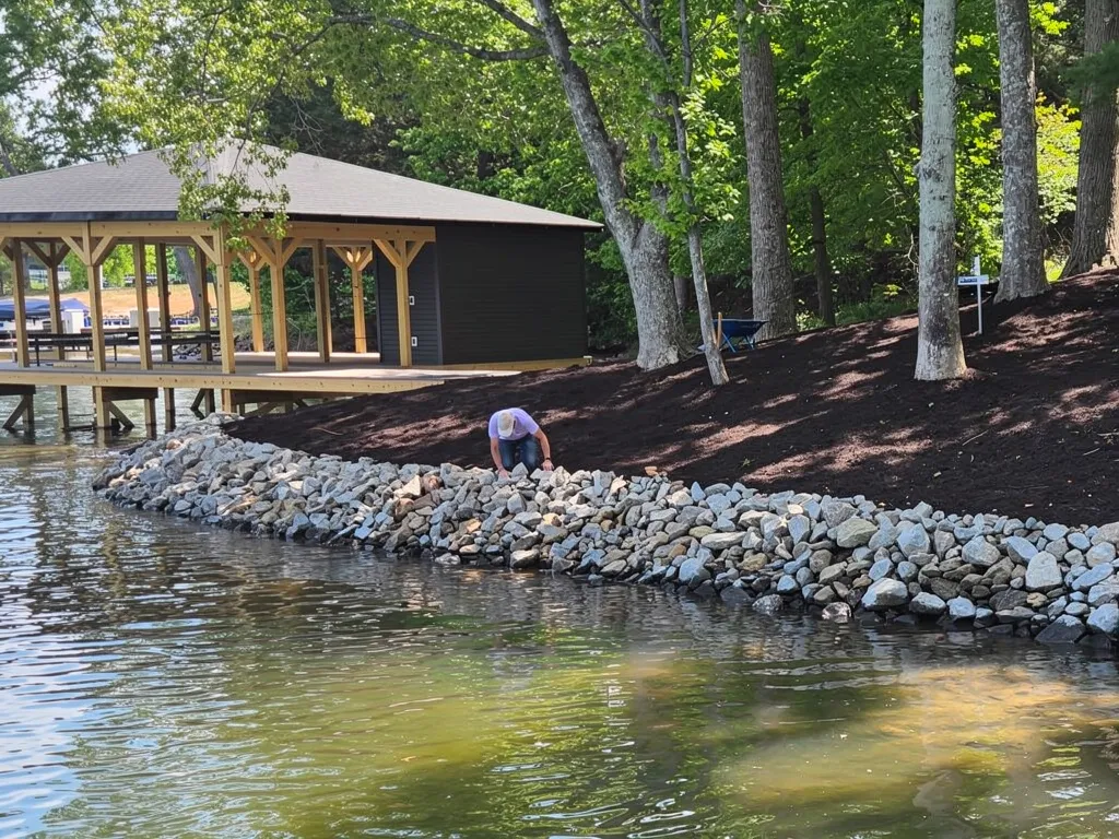 Inspector checking a seawall for cracks and shifting at Lake Anna