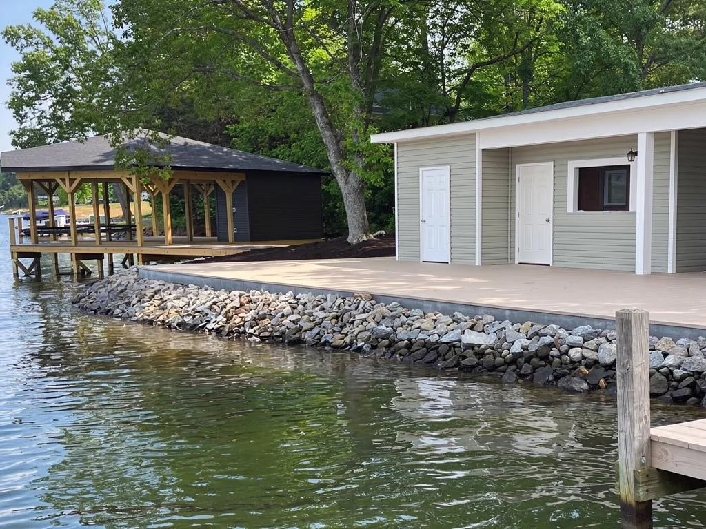 Homeowner and contractor reviewing seawall design plans at Lake Anna