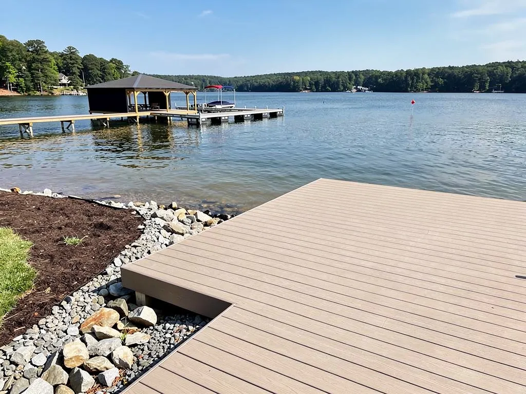 Composite deck extending over calm water at a lakefront property