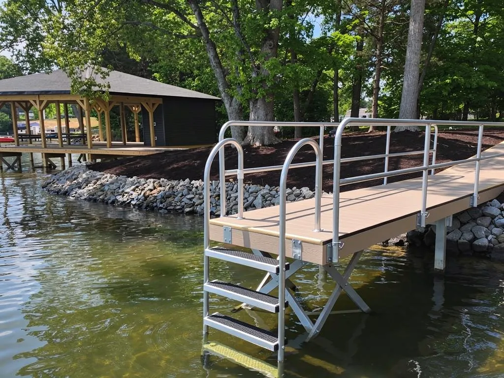Swimmer using a secure dock ladder with non-slip treads and railing